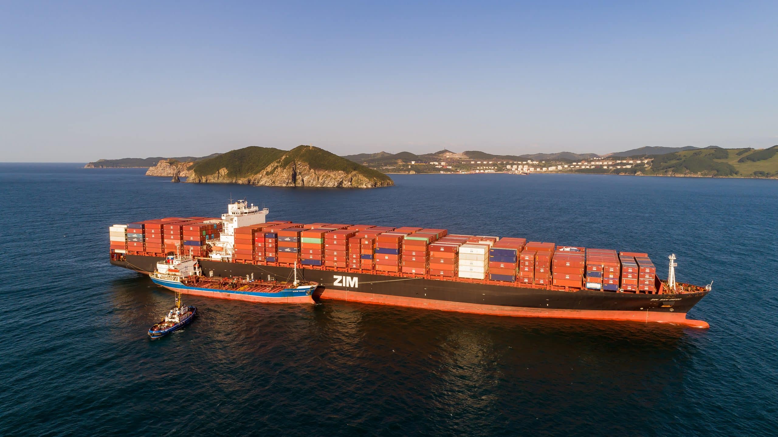 A large container ship loaded with goods at sea, illustrating the need for goods insurance for businesses engaged in transport and storage.